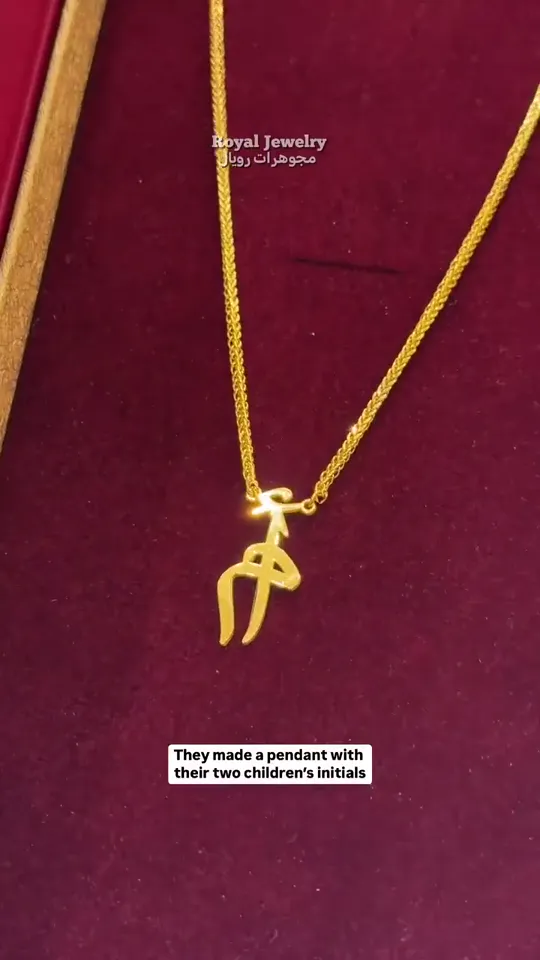 A pendant made from two children's initials